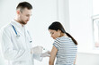 © SHOTPRIME STUDIO - male doctor giving an injection to a patient in a hospital coronavirus