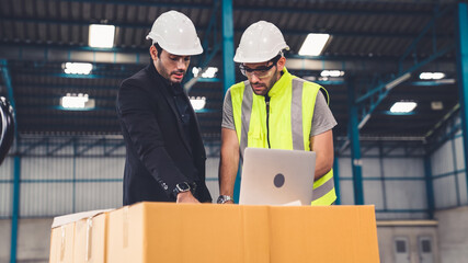 two factory workers working and discussing manufacturing plan in the factory . industry and engineer