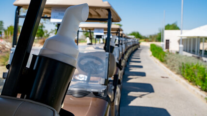 background image of multiple golf carts parked in order.