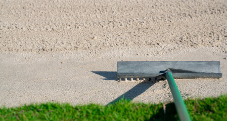Wall Mural - Rake in the sand trap on a golf course