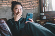 © ATKWORK888 - Happy Asian woman using mobile phone.