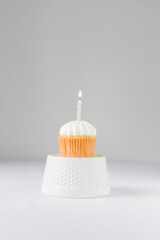 Sticker - Cupcake with a white frosting and a silver lit candle, birthday cupcake with a candle