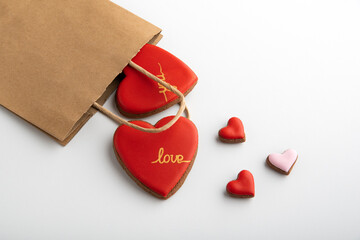 Package and gingerbread red hearts on white background. Gift for lovers. Valentines day.