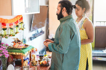 Poster - Indian husband and wife celebrating hindu festival at home - Focus on man face