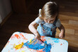 © kaloriya - Child painting with paintbrush on the table at home