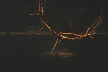 Crown Of Thorns On Wooden Table, Closeup With Space For Text. Easter Attribute