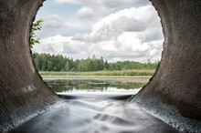 Perfect View From Concrete Drain Pipe In The Forest River. Beautiful Water Flow From The Lake.
