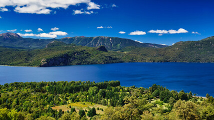 Landscape of lake Lacar, San martin de los Andes, Neuquen, Argentina. Taken on a warm summer afternoon under a ble sky with a few white clouds 