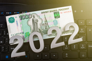 close-up. Black background. on it are numbers 2022 and a bill of 1000 rubles. Russia.