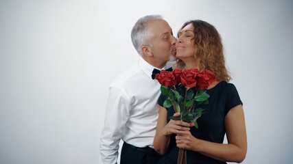 Wall Mural - A loving elderly man gives his elderly wife red roses for the anniversary.