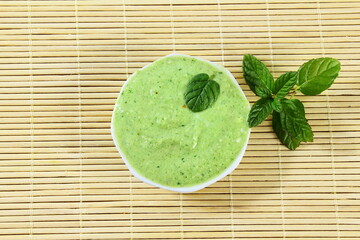 traditional homemade indian gujrati snack food recipe mint green chutney for serve with ganthia, fafda or pakoda