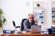 © Elnur - Old male businessman employee working in the office