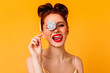 © Look! - Playful caucasian woman holding lollipop. Gorgeous red-haired girl posing with hard candy.