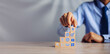 © A Stockphoto - Businessman hand arranging wood block with icon business strategy and Action plan