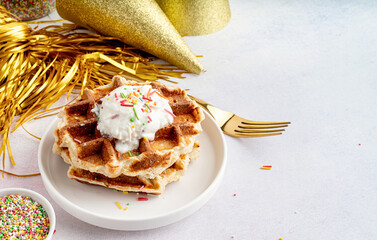 Birthday party waffles with youghurt and colorful sprinkles