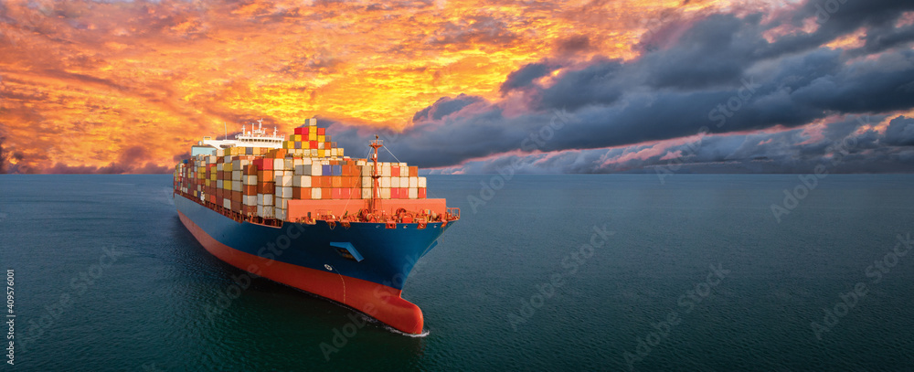 Aerial side view of smart cargo ship carrying container from custom container depot go to ocean concept freight shipping by ship service on sunset sky background. - obrazy, fototapety, plakaty 