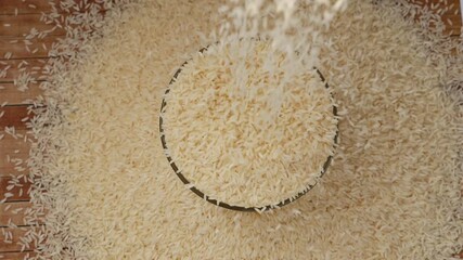 Sticker - Close view of dropping rice over a bowl filled with white rice