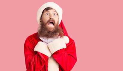 Sticker - Handsome young red head man with long beard wearing santa claus costume shouting and suffocate because painful strangle. health problem. asphyxiate and suicide concept.