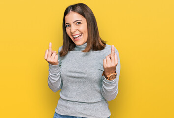 Sticker - Young beautiful woman wearing casual turtleneck sweater showing middle finger doing fuck you bad expression, provocation and rude attitude. screaming excited