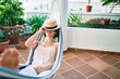 © Krakenimages.com - Young beautiful caucasian woman smiling happy resting on a hammock at home