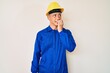 © Krakenimages.com - Young hispanic boy wearing worker uniform and hardhat looking stressed and nervous with hands on mouth biting nails. anxiety problem.