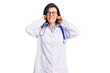 © Krakenimages.com - Young beautiful woman wearing doctor stethoscope and glasses covering ears with fingers with annoyed expression for the noise of loud music. deaf concept.