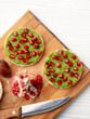 © SerPhoto - Rice cakes with avocado mash and pomegranate seeds vertical frame