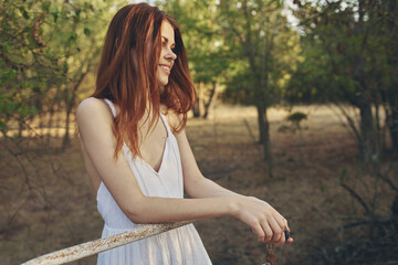 Wall Mural - romantic woman outdoors in the garden back view model red hair