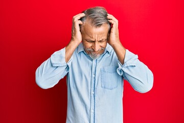 Canvas Print - Middle age grey-haired man wearing casual clothes suffering from headache desperate and stressed because pain and migraine. hands on head.