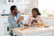 © Prostock-studio - Happy Black Spouses Having Breakfast In Kitchen Together, Chatting And Laughing