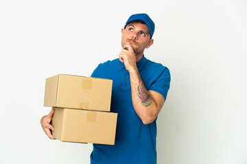 Delivery caucasian man isolated on white background and looking up