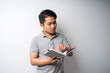 © SafwanAbdRahman - Portrait of Asian man holding book with face expression