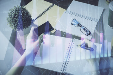 Multi exposure of woman on-line shopping holding a credit card and financial graph drawing. Stock market E-commerce concept.