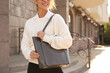 © New Africa - Woman with stylish shopper bag outdoors, closeup