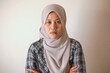 © airdone - Asian muslim woman wearing hijab looking at camera with neutral expression, diverse people portrait