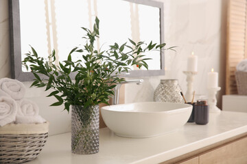 Canvas Print - Vase with beautiful branches and fresh towels near vessel sink in bathroom. Interior design