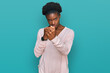 © Krakenimages.com - Young african american girl wearing casual clothes ready to fight with fist defense gesture, angry and upset face, afraid of problem