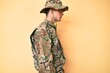 © Krakenimages.com - Young handsome man wearing camouflage army uniform looking to side, relax profile pose with natural face with confident smile.