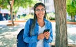 © Krakenimages.com - Young african american student woman smiling happy using smartphone at the university campus