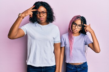 Canvas Print - Beautiful african american mother and daughter wearing casual clothes and glasses pointing unhappy to pimple on forehead, ugly infection of blackhead. acne and skin problem