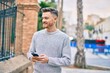 © Krakenimages.com - Young caucasian man smiling happy using smartphone at the city.