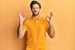 © Krakenimages.com - Young hispanic man wearing casual yellow t shirt relax and smiling with eyes closed doing meditation gesture with fingers. yoga concept.