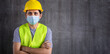 © anut21ng Stock - Portrait construction worker wearing a face mask safety Coronavirus 2019 (COVID-19) on cement wall background with copy space