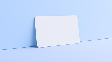 Blank credit card mockup resting on a wall in realistic 3D rendering. Rounded corners business card mock up for design template