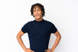 © luismolinero - Young african american man isolated on white background posing with arms at hip and smiling