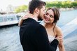 © Наталья Котковец - Close up of the young Caucasian beautiful woman and handsome man on their wedding day, fiance hugging and kissing his fiancee.