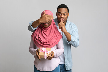 Wall Mural - Happy young black guy making surprise for his girlfriend