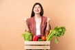 © luismolinero - Young farmer girl with freshly picked vegetables in a box celebrating a victory in winner position