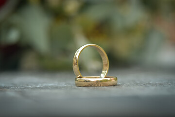 A pair of gold wedding rings with bokeh background