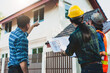 © Wasan - Team of construction inspectors discuss and use the plan to inspect the construction project. Client and Contractor discussing plan to renovation house.
